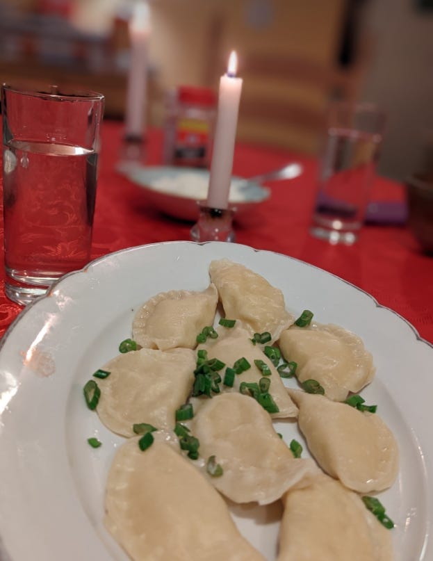 A platter of home made perogi and a candle in the background