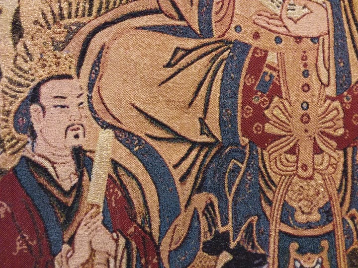 Detailed tapestry featuring a bearded man in traditional attire with ornate decorations.